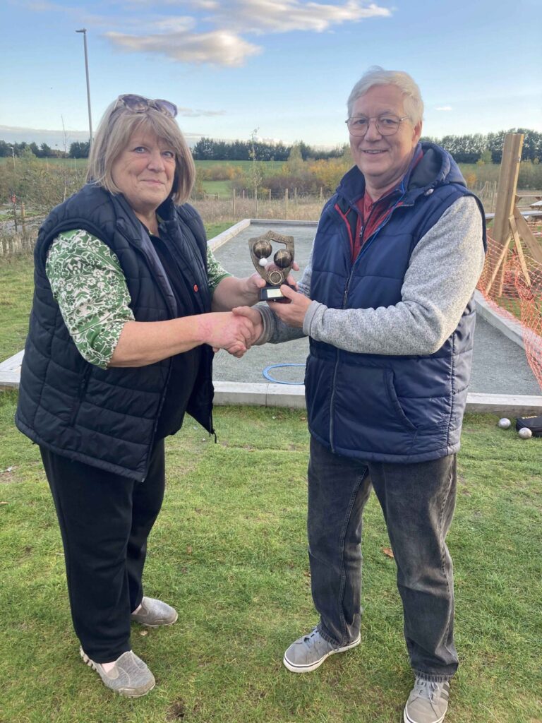 Pétanque Joint Individuals trophy winner 2023 Judy receiving her trophy from Group leader Alec
