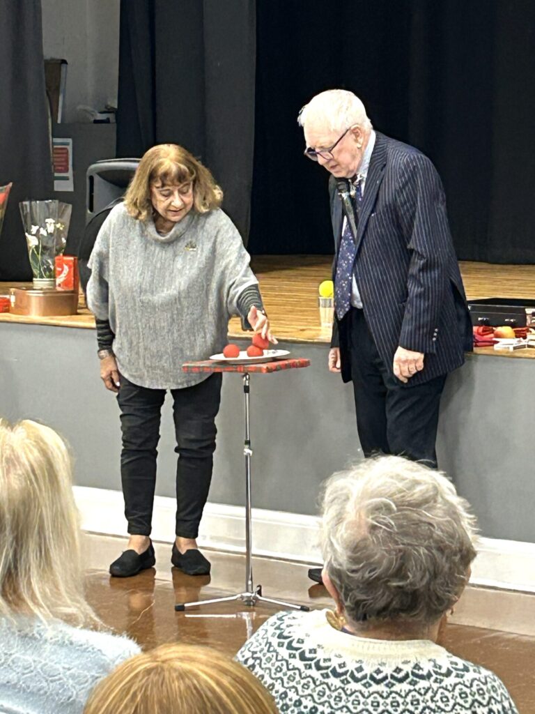 John Richard with member helping with his magic.