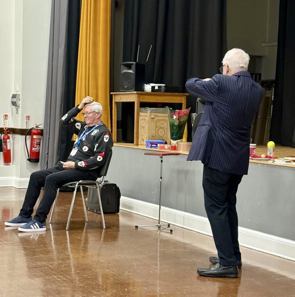 John Richard with Alec helping with his magic.